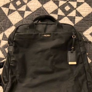 Black and gold Tumi women’s convertible backpack